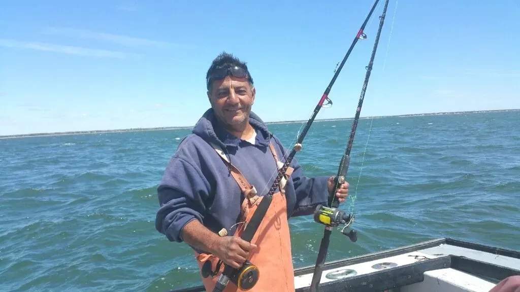Capt. Jim aboard the PESCE on Cape Cod with rod in hand